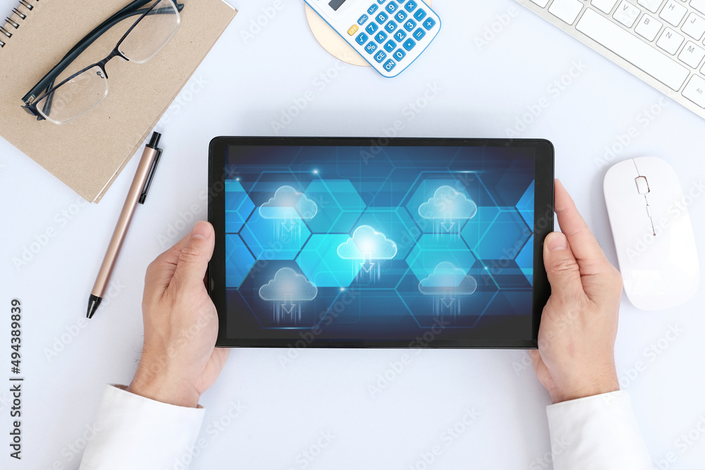 Poster hand using tablet with cloud computing technology internet storage network concept and a large datab