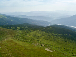 Naklejka premium High mountains of the Ukrainian Carpathians in cloudy weather. Aerial drone view.