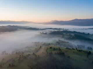 Sunrise over the fog in the Ukrainian Carpathians. Aerial drone view.
