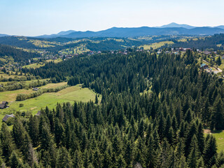 Fototapeta na wymiar Green mountains of Ukrainian Carpathians in summer. Sunny clear day. Aerial drone view.