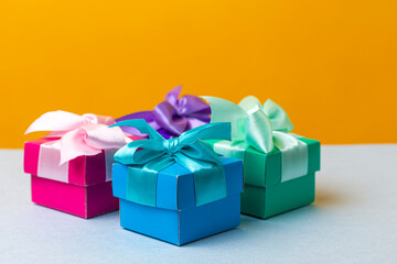 Upper View of Wrapped Christmas and New Year Gifts of Various Colors Placed in Line on Yellow Blue  Background.