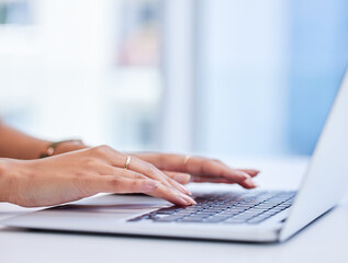 Shes got reports to finish. Cropped shot of an unrecognizable businesswoman working on her laptop...