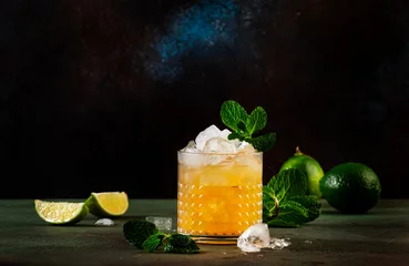 Foto op Plexiglas Mai Tai trendy alcoholic cocktail with rum, liqueur, syrup, lime juice, mint and crushed ice. Dark background, bar tools, copy space © 5ph