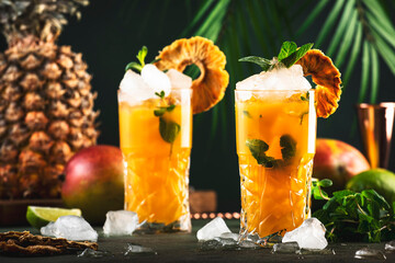 Alcoholic cocktail with vodka, pineapple juice, mango, liquor, ice. Long drink or summer mocktail....