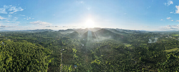 Aerial drone Landscape Panorama view,Top view sun's rays spread and covered the mountain area. Orange glow of the sun was above the mountains.