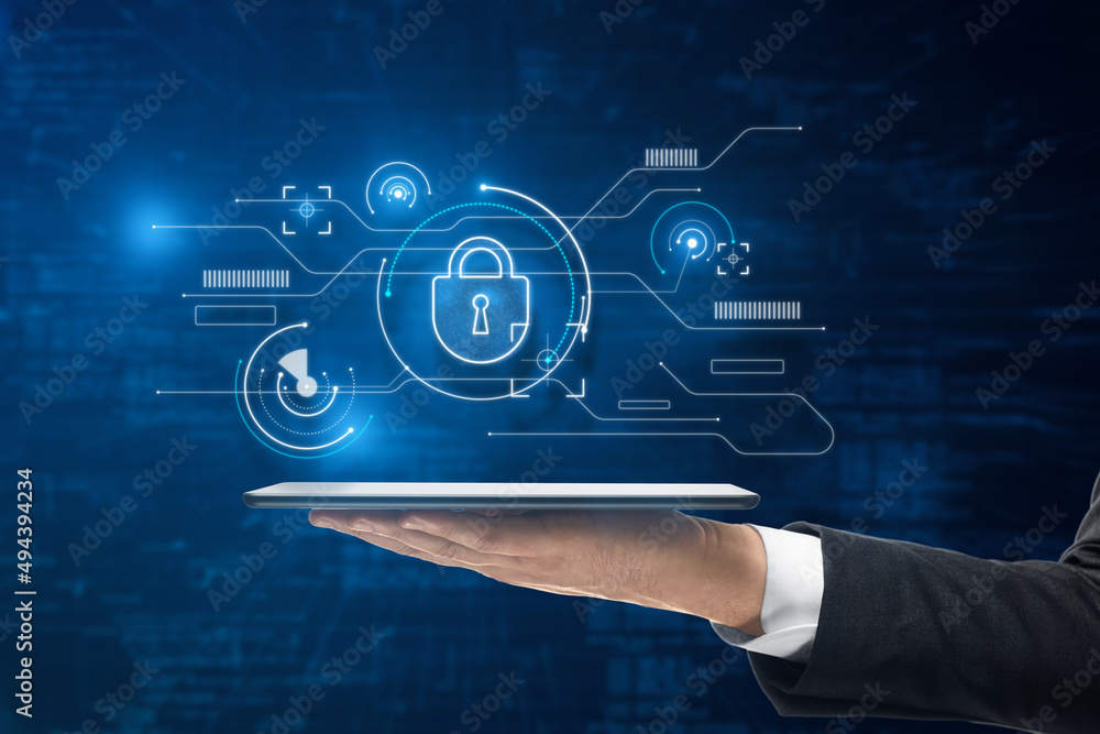 Poster Close up of businessman hand holding tablet with abstract internet safety and security interface with padlock and business charts on blurry blue background. Secure and cyber concept.