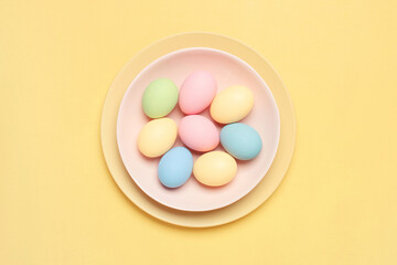 Fototapeta na wymiar Easter colored pastel eggs on the plate, holiday card