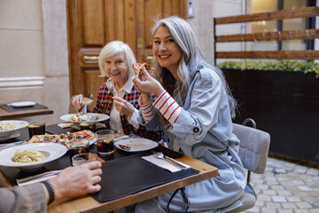 Cheerful women chatting and laughing in cafe