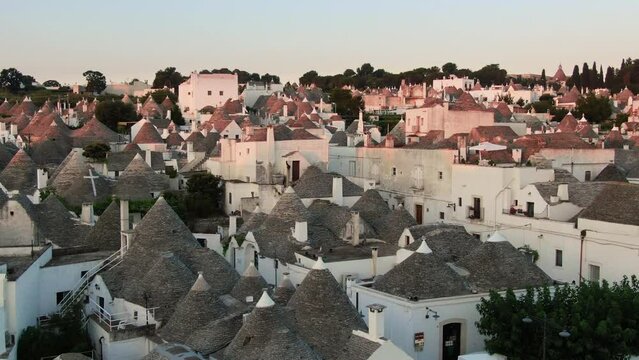 trulli di alberobello aerial view drone ascending over old town historic center at sunrise,italian landmark small village puglia italy 4k
