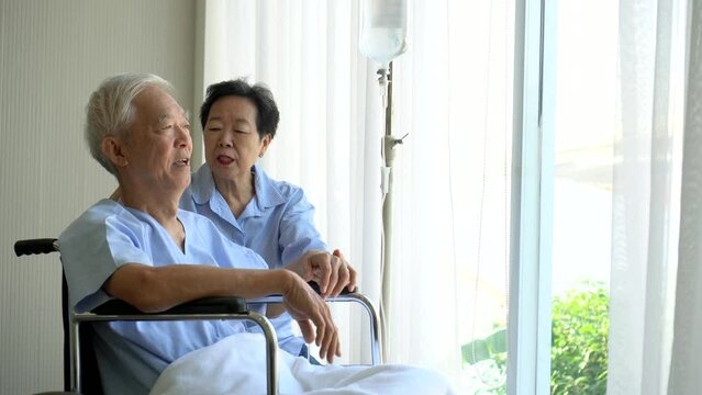 Asian senior elder couple on wheel chair talking sharing having coversation