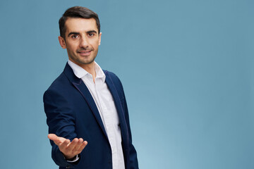 Business man extending his hand in business suit Leader blue isolated background copy-space professional development Copy space
