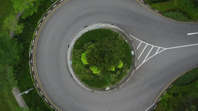 Drone zooming out on a circle road in slow panning pace clip 1