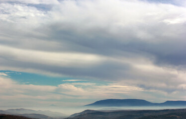 foggy mountain and clouds in the sky