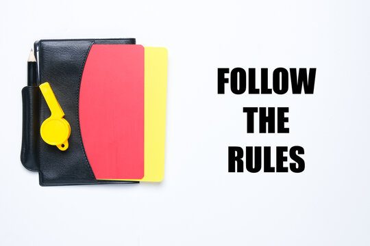 A picture of referee set book and follow the rules word. Obey and abide the law concept.