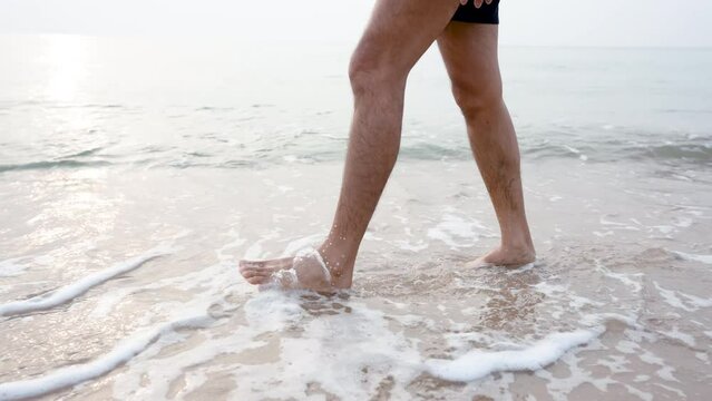 4K 25fps Slow Motion, Close-up of feet walking comfortably on the beach, with gentle waves hitting your feet, feeling refreshed and cool, popular tourist attraction