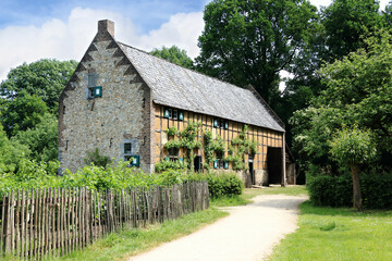 old stone farmhouse in a typical Flemish landscape