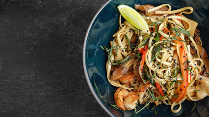 Spaghetti with seafood on a dark background