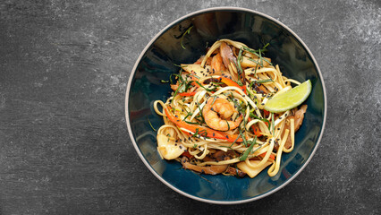 Spaghetti with seafood on a dark background