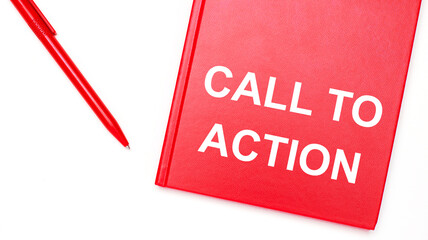 The text CALL TO ACTION is written on a red notepad near a red pen on a white table in the office. Business concept