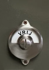 Foto auf Leinwand a metal revolving sign on a door with the dutch inscription Vrij, which means not occupied © Marcus