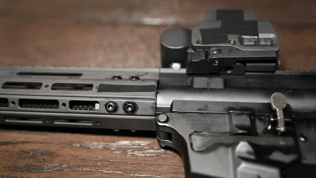 slow slide over a high-end AR style 9mm pistol called a personal protection weapon with holographic sight