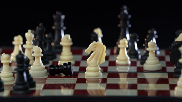 Business strategy concept. Chess. Pawn moved by knight. Ihute horse moves. Horse, chess pieces are located on a wooden board. Leadership in the life of a horse. Game good for brain intelligence
