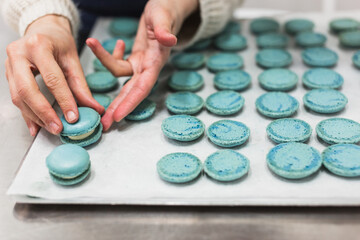 Pastry chef making macarons in pastry shop