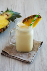 Homemade Pineapple Mango Banana Smoothie in a Glass Jar, side view.