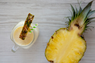 Homemade Pineapple Mango Banana Smoothie in a Glass Jar, top view. Flat lay, overhead, from above.