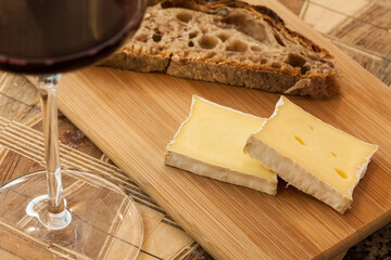 Close up of red wine served with cheese and bread 