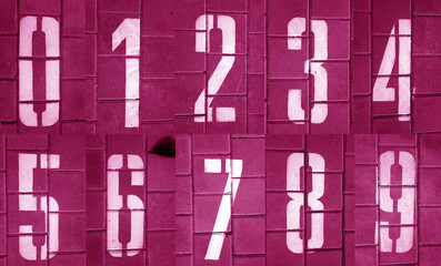 Numbers from zero to nine on pavement in pink tone.