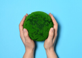 Hands with a green planet