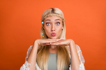 Portrait of attractive funny amazed blond girl sending you air kiss isolated over bright orange color background