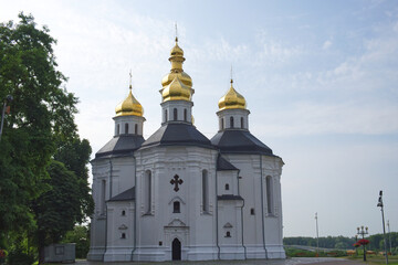 Fototapeta na wymiar Beautiful cloudy sky over the ancient Orthodox Church of St. Catherine in the Ukrainian city of Chernihiv. An example of Ukrainian baroque architecture.