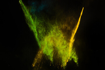 Freeze motion of colorful dust explosion on black background for Happy Holi