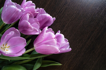 Training, master classes and floristry courses making a bouquet. Beautiful romantic bouquet of pink tulips on a wooden background for your text.
