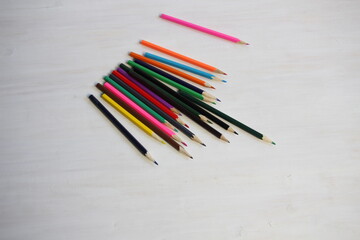 pencils of different colors  on wooden white table