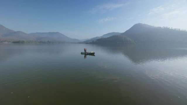 Enjoy city break alone relax rural river life on beauty fog paddling OAR rowing on calm aqua sport outside. Active solo serene people wide drone view happy get away escape summer nautical vessel trip.