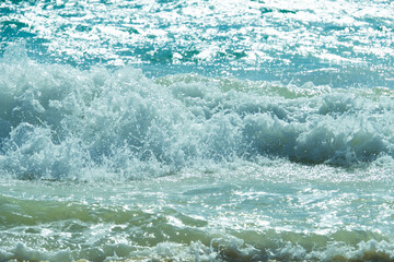 Fototapeta na wymiar Sea waves in motion. Blurred splashing waves. Raging water surface.