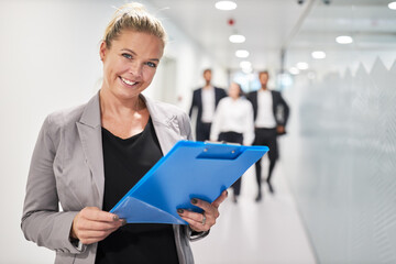 Smiling business woman with checklist on clipboard