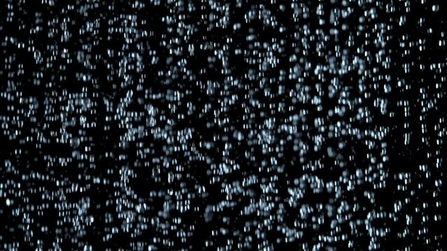 Super Slow Motion Shot of Many Water Drops Falling Down on Black Background at 1000fps.