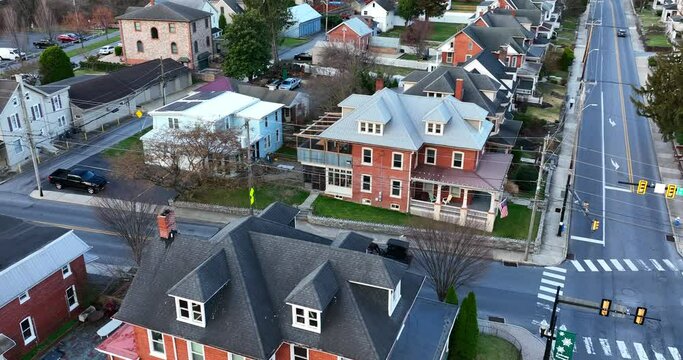 Rising reveal of horse and buggy carriage in town in USA. Old fashioned transportation in modern USA. Aerial view.