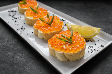 Bruschetta with red caviar, with lemon and green onions
