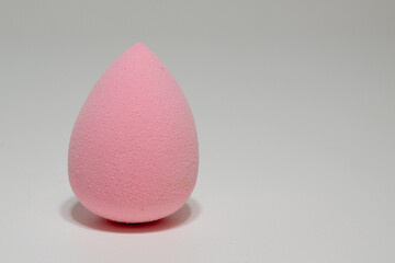 pink sponge for cosmetics on a light background