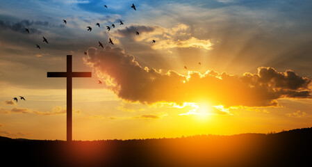 Fototapeta na wymiar Christian cross on hill outdoors at sunrise. Resurrection of Jesus.