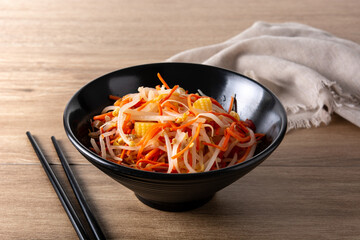 Healthy Chinese cabbage salad in bowl on wooden table	