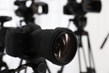 Fototapeta na wymiar Modern video camera indoors, focus on lens. Professional media equipment for broadcasting event