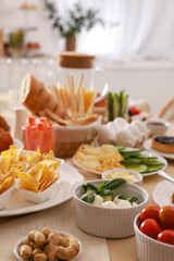 Dishes with different food on table in room. Luxury brunch