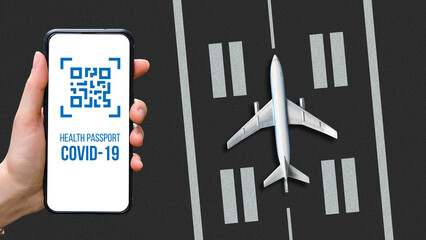 The concept of an electronic health passport in a phone with a QR code for an airplane flight