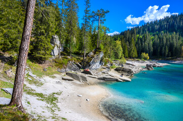 Paradise beach in bay of Cauma Lake (Caumasee) with crystal blue water in beautiful mountain...